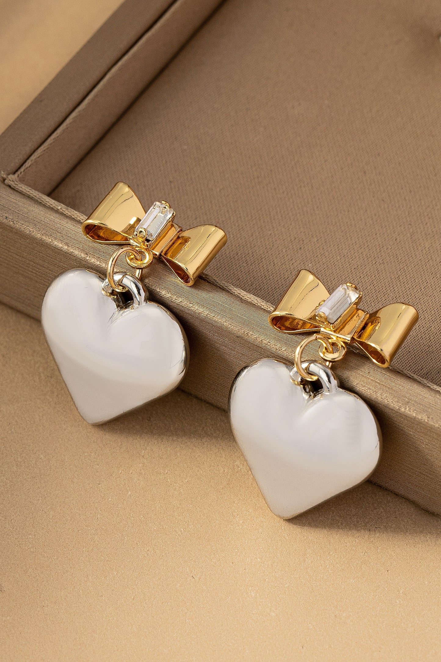 Two tone puffy heart and bow drop earrings