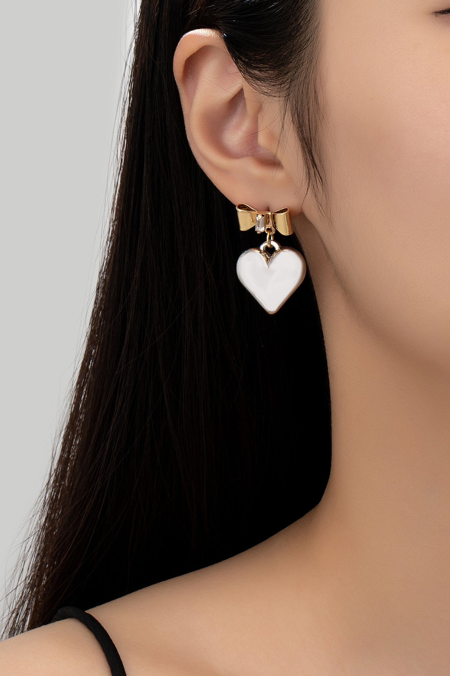 Two tone puffy heart and bow drop earrings